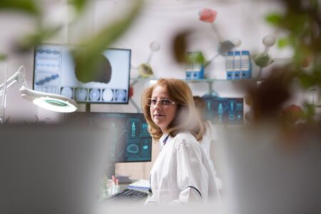 Portrait of middle age woman in a plant laboratory. Microbiological laboratory. Quality control.の写真素材