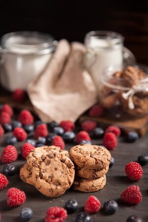 Delicious chocolate chips gouped in a pile with raspberries. Delicious pastry. Breakfast idea.の写真素材