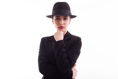 Attractive Caucasian female posing looking into the camera with hands on her chin over white  in...