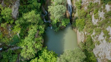 Top view of waterfall in a lake in the middle of de forest. Arial view waterfallの写真素材