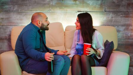 Young couple having a conflict at one of theirs best friends party after drinking too much alcohol.