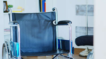 Wheelchair with leather seat in empty room for handicap people.の写真素材