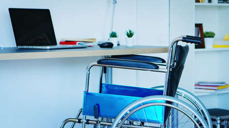 Wheelchair for people with mobility disability in empty room.の写真素材