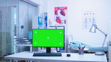 Chroma key on computer in hospital cabinet with medical personnel in the background.の写真素材