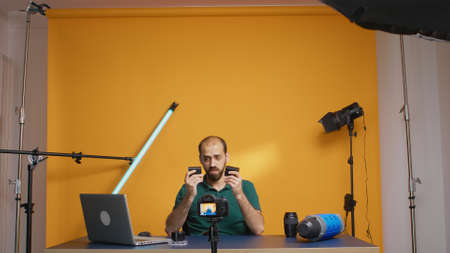 Videographer recording review of rechargeable batteries for camera.の写真素材