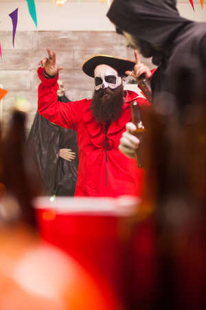 Man dressed up like a party with a big medieval hat celebrating halloween.