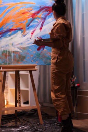 Painter in art studio using creativity to realize a successful painting. Modern artwork paint on...