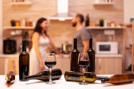 Empty bottles of wine after couple celebrating marriage.の写真素材