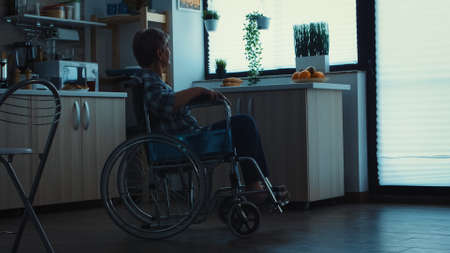 Silhouette of depressed handicapped senior woman in wheelchair from leg injury. Elderly disabled pensioner in rehab, paralysis and disability for invalid full of sorrow, worry and sad face. Retirement period for old peopleの写真素材