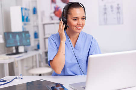 Medical staff talking with patient about prescription wearing headset with microphone in hospital...
