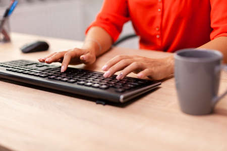 Unrecognizable businesswoman entrepreneur typing finance communication in workplace.の写真素材