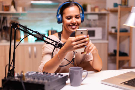 New media star using smartphone in home studio and recording vlog. Creative online show On-air...