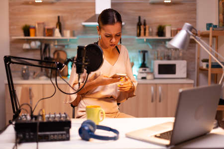 Social media star answering questions from online using phone in podcast. Creative online show...