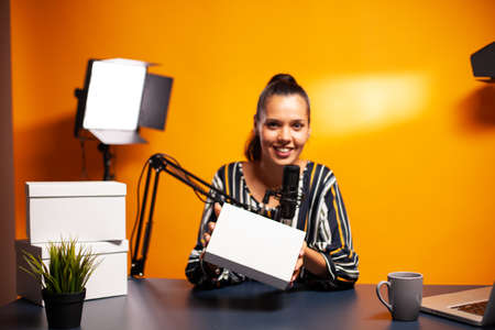 Vlogger holding box during broadcast on social media. . Creative content creator influencer expert...