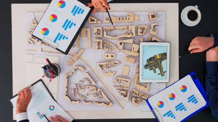 Top view of business people engineers planning ambitious turbine project brainstorming working on...