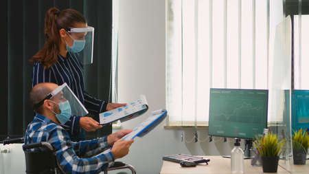 Business people wearing protective mask in new normal office making strategy, businessman sitting in...