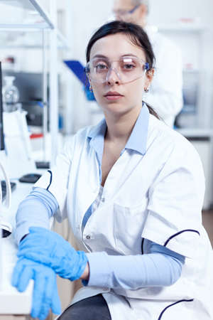 Successful scientist in genetics looking at camera in research laboratory Chemist wearing lab coat...