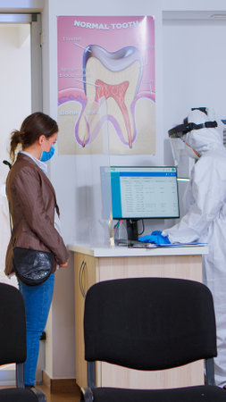 Patients with protection mask waiting in stomatology reception with new normal, staff wearing ppe...