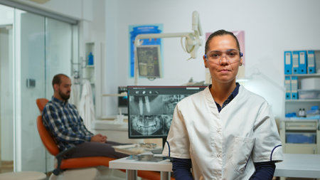 Stomatologist doctor talking on web cam with patients about oral hygiene looking at camera while...