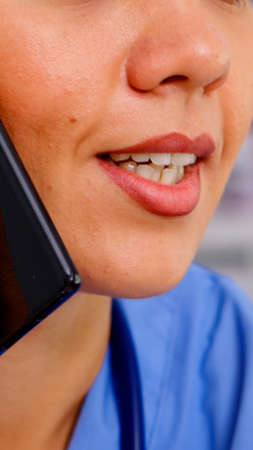Healthcare physician consulting remote patients using phone in hospital wearing medicine uniform....