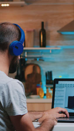 Man designer using cad software to design a 3D concept of buildings working overtime from home....