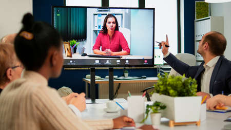 Woman ceo speaking at webcam during virtual business video presentation for business partners. Confident businesswoman talking to web cam streaming webcast training, doing online conference call.の写真素材