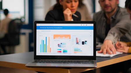 Laptop screen ready for financial project presentation placed on desk while business people work in...