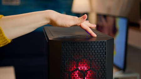 Woman gamer power on computer unit preparing for gaming tournament. Cyber performing on powerful...