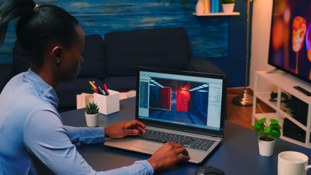Young african woman gamer testing online professional game on laptop at home late at night....