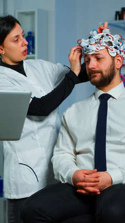 Women team neurological researchers working together developing treatment for diagnosis of...