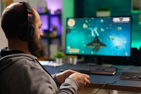 Videogamer playing graphics cyberspace sitting on gaming chair using technology network wireless....