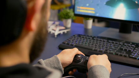 Close-up of gamer playing first person online competition using professional wireless controller....