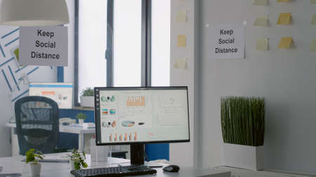 Empty business modern office with plastic separators and keep social distance sign on the wall....