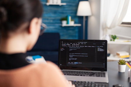 Young developer programming software typing html code deloping application for mobile use. Student...