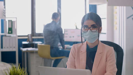Portrait of entrepreneur woman wearing face mask to avoid infection with during global pandemic....