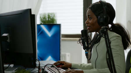 Sad black woman gamer with headphone streaming videogames in gaming home studio losing competition....