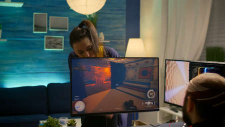 Girlfriend shuts down pro gamer computer during first person tournament in gaming home studio. Cyber...