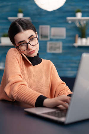 Student browsing information on laptop computer for digital seminar. Teenager woman speaking at...