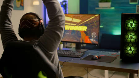 Videogamer playing graphics cyber space sitting on gaming chair using technology network wireless....