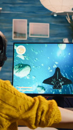 Expert woman gamer playing space shooter video game on powerful PC. Virtual shooter game...