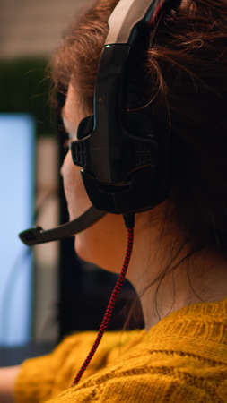 Gamer playing video game on championship discussing with teammates using mic of headset. Pro-gamner...