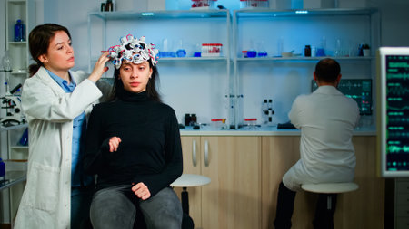 Medical lab technician adjusting eeg headset monitoring brain functions, descovering diagnosis of...