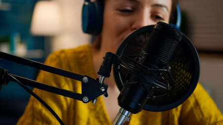 Creative show vlogger presenter recording sound in home studio for podcast. On-air online production internet broadcast show host streaming live content for digital social media using internet webの写真素材