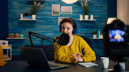 Creative vlogger recording podcast using production station in home studio. Creative online show On-air production internet broadcast host streaming live content, digital social media communicationの写真素材