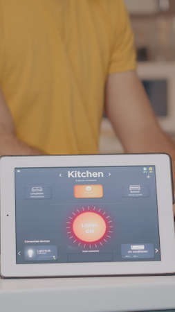 Smart gadget responds to commands, man controlling electricityの写真素材