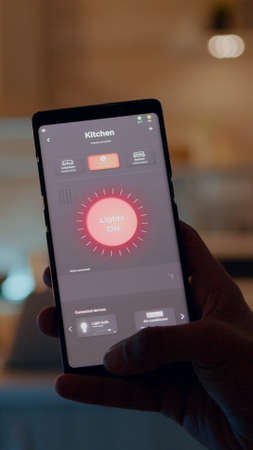 Man holding smartphone with lighting control application
