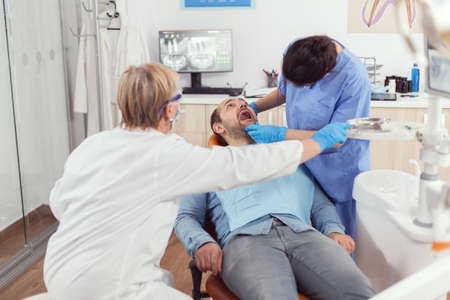 Senior dentist woman preparing tools for oral surgery