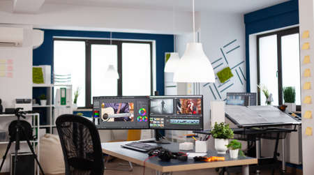 Video editing start up studio company with no people in it and post production software on pc displaysの写真素材