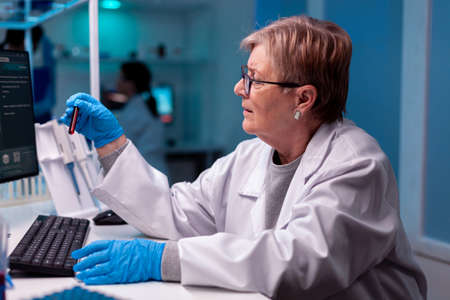 Scientist analysing blood test sample in medical facility hospital.の写真素材