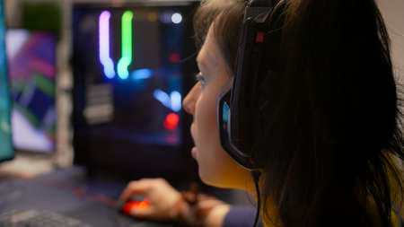 Close-up of pro gamer talking with friends on networks for space shooter virtual competition....